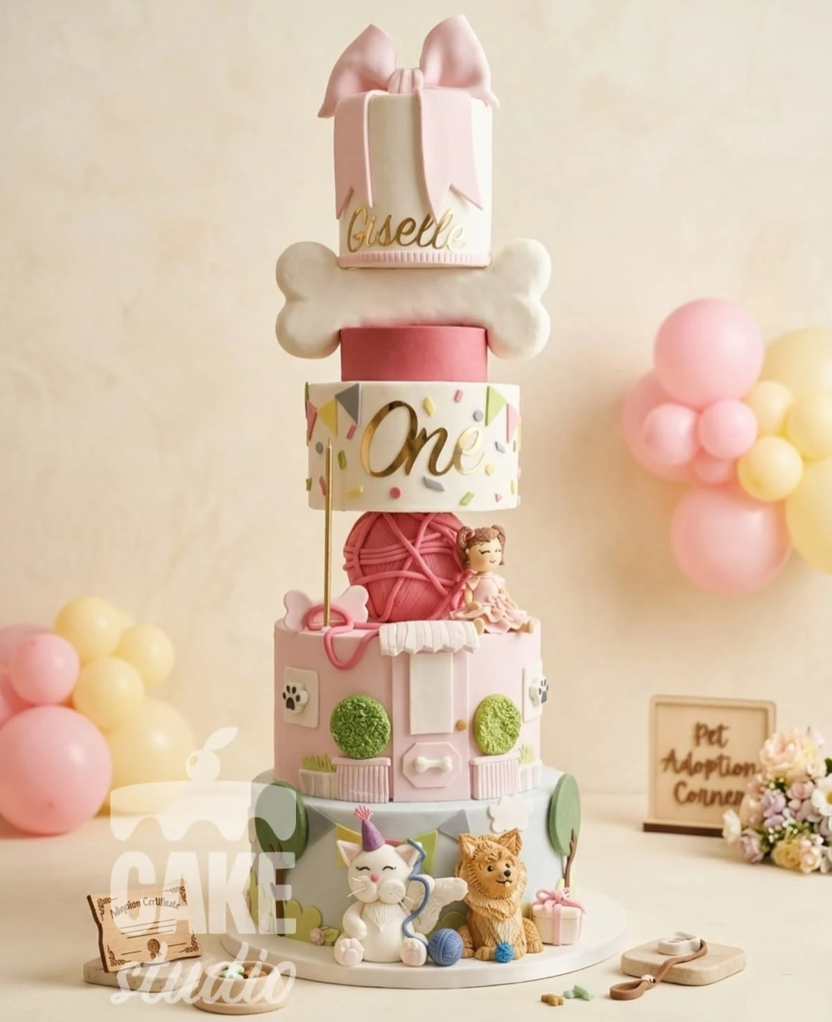 Pastel de cumpleaños en tonos rosa con lazo, mascotas y detalles de adopción, elaborado por Cake Studio